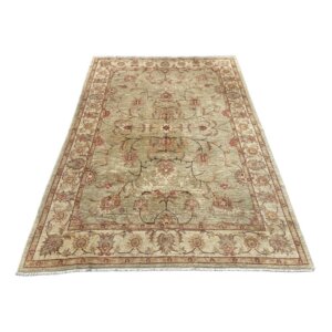 This 8x11 Ziegler Sultanabad-style hand-knotted area rug features a soft, muted palette with an elegant allover floral design and a decorative border that gives it a refined yet relaxed antique-inspired look. Its subtle green, ivory, rose, and gold tones make it especially versatile for a living room, dining room, bedroom, or library where a lighter traditional rug is desired.